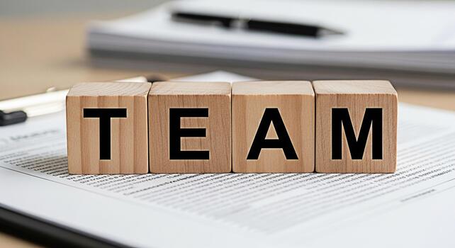 de madera bloques ortografía equipo descansando en un contrato en un brillante oficina simbolizando colaboración unidad y el importancia de trabajo en equipo en lograr negocio éxito y Fomentando un positivo trabajo medio ambiente foto