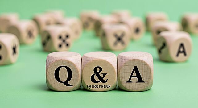 Wooden dice displaying Q A on a green surface representing questions and answers in a learning environment fostering curiosity and knowledge acquisition photo