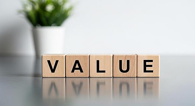 Wooden blocks spelling VALUE on a reflective surface conveying importance and worth in a clean modern environment symbolizing business ethics personal values and financial principles photo