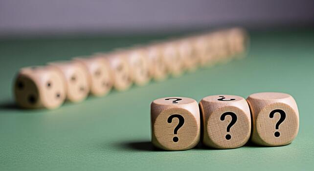 Wooden dice displaying question marks on a green surface posing challenging questions and inviting contemplation symbolizing uncertainty problemsolving and the quest for answers in a complex world photo