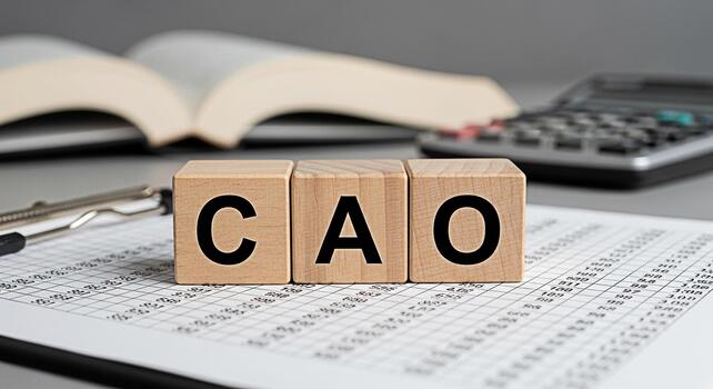Wooden blocks spelling CAO on a financial report with an open book and calculator in the background representing the role of a Chief Accounting Officer in financial management and reporting photo