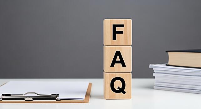 Wooden blocks spelling FAQ on a white desk representing frequently asked questions in a business or educational setting creating a sense of clarity and information for customers or students photo