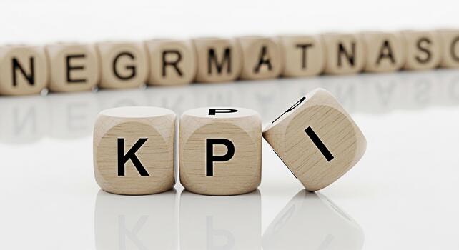 Wooden dice spelling out KPI in a bright studio setting representing key performance indicators and business metrics for strategic planning and achieving organizational goals with a focus on success photo