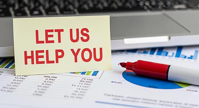 Supportive business concept with a note saying Let Us Help You placed on financial charts and a laptop conveying a message of assistance and guidance in a professional setting fostering trust and coll photo