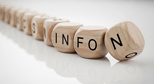 Wooden blocks spelling out INFO on a white surface with the last block falling over symbolizing information overload and the importance of reliable data in a modern fastpaced environment photo