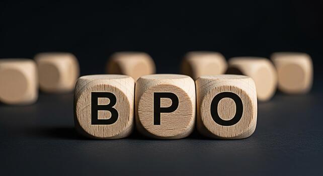 Wooden cubes displaying BPO on a dark surface representing business process outsourcing solutions and strategies symbolizing efficiency and global business operations in a corporate environment photo