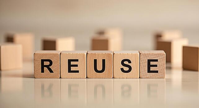 Wooden blocks spelling REUSE on a reflective surface promoting environmental awareness and sustainability in a bright minimalist setting symbolizing ecofriendly practices and responsible consumption f photo