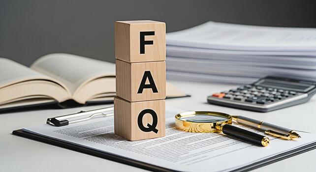 Wooden blocks displaying FAQ on a bright desk with an open book calculator and pen representing information assistance and answers to common questions in a professional setting photo