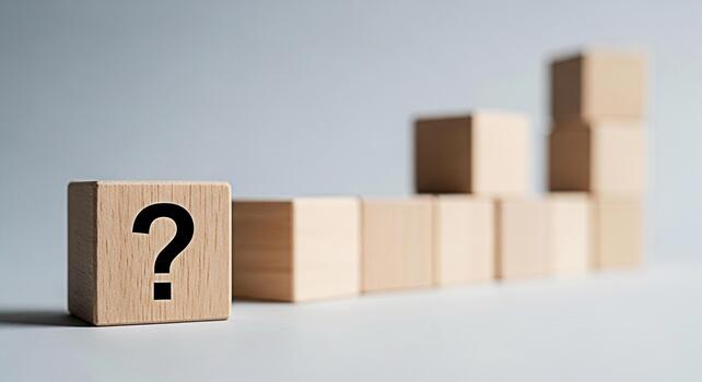 Wooden block displaying a question mark symbol in a minimalist setting representing uncertainty and the search for answers leading to growth and success in a business context fostering curiosity photo
