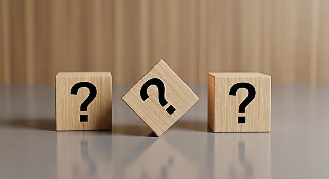 Three wooden blocks displaying question marks sitting on a reflective surface against a wood grain backdrop representing uncertainty problemsolving and the search for answers in a clean minimalist set photo