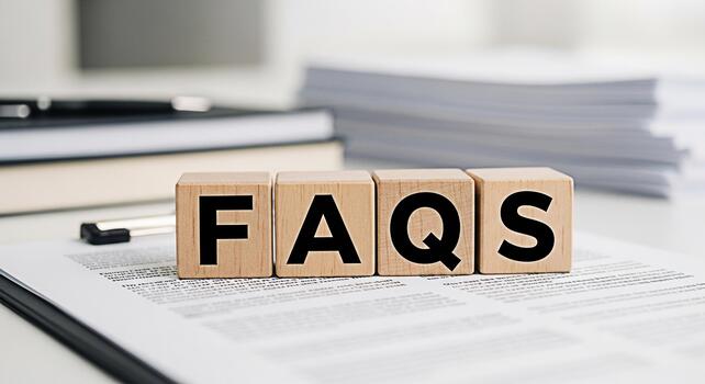 Wooden blocks spelling FAQs on a document in a bright office setting representing frequently asked questions information resources and customer support for business and online help photo