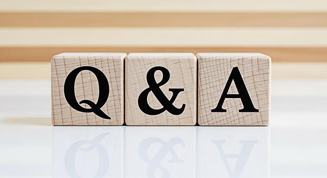 Wooden blocks displaying Q A on a reflective surface representing knowledge and information sharing in a clean bright environment symbolizing clarity and solutions to questions photo