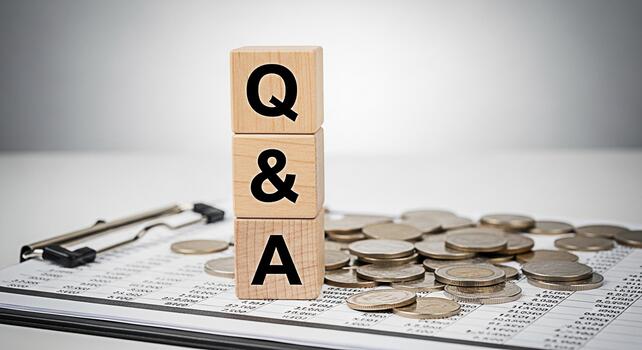 Wooden blocks displaying QA on a financial report with scattered coins representing financial questions and answers in a business setting conveying a sense of clarity and financial insight photo