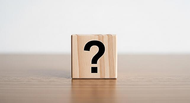 Wooden block displaying a question mark on a wooden surface symbolizing uncertainty and the search for answers in a clean minimalist setting evoking curiosity and the need for problemsolving photo