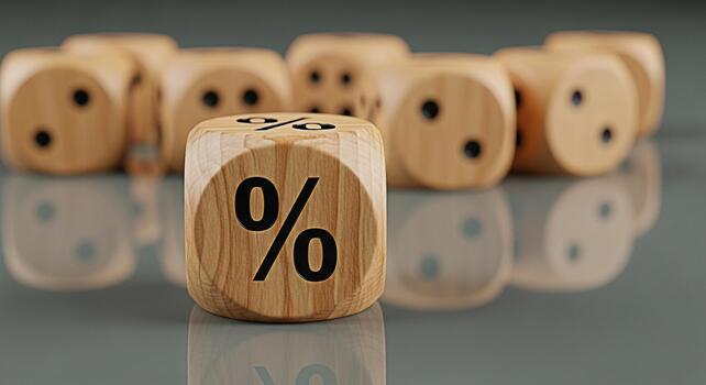 Wooden dice displaying a percentage sign on a reflective surface symbolizing financial rates and discounts creating a concept of risk and opportunity in a business and investment setting photo