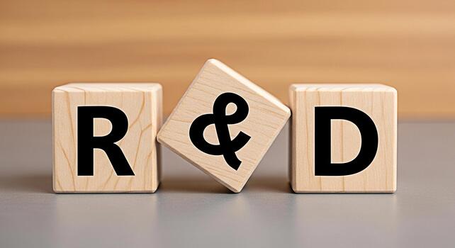 Wooden blocks displaying RD on a gray surface symbolizing research and development innovation and business strategy in a clean modern setting conveying a sense of progress and forwardthinking photo