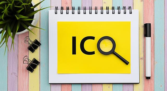 Closeup of ICO text on yellow paper with magnifying glass on a colorful wooden desk symbolizing investment analysis and financial opportunity in a vibrant and optimistic setting photo