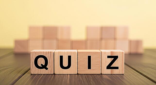 Wooden blocks spelling QUIZ on a wooden table representing a challenge and knowledge assessment in an educational environment creating a playful and engaging learning atmosphere with a bright backgrou photo