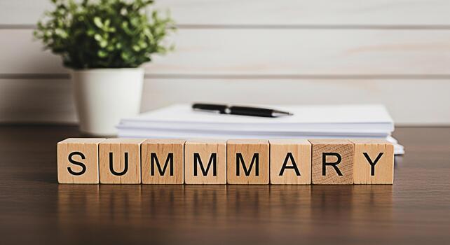 Wooden blocks spelling SUMMARY on a wooden desk with a pen and stack of paper in a bright office representing concise information and effective communication for business and education photo