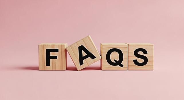 Wooden blocks spelling FAQs on a pink background representing frequently asked questions and information creating a clear and accessible resource for customers and visitors promoting clarity and under photo