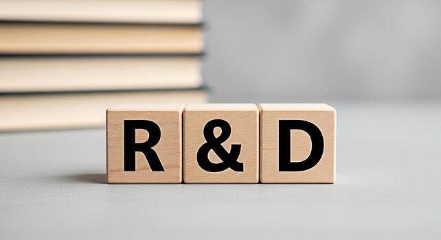 Wooden blocks displaying RD on a gray surface symbolizing research and development in a minimalist setting conveying a sense of innovation learning and the pursuit of knowledge in business and science photo