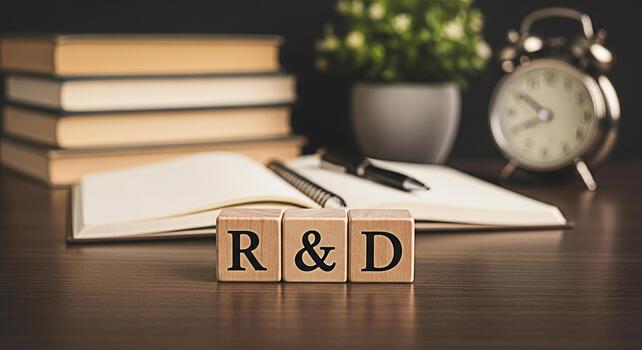 Wooden blocks spelling RD on a desk with books an open notebook pens a plant and an alarm clock symbolizing research and development in a focused and academic environment photo