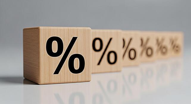 Wooden blocks displaying percentage signs in a row on a reflective surface symbolizing financial rates interest and discounts in a clean modern setting creating a sense of stability and precision photo