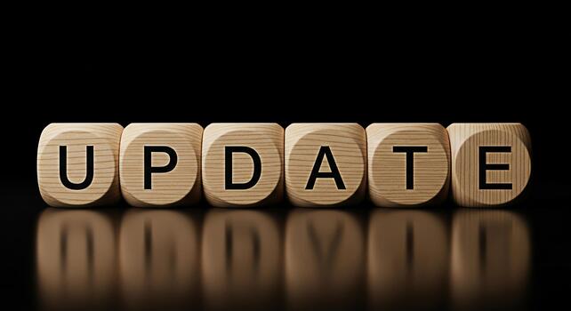 Wooden blocks spelling UPDATE on a reflective black surface conveying a sense of progress and modernization symbolizing software updates system upgrades and the importance of staying current in a digi photo