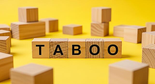 Wooden blocks spelling TABOO on a vibrant yellow background representing forbidden topics and sensitive issues creating a sense of caution and awareness about cultural and social norms photo