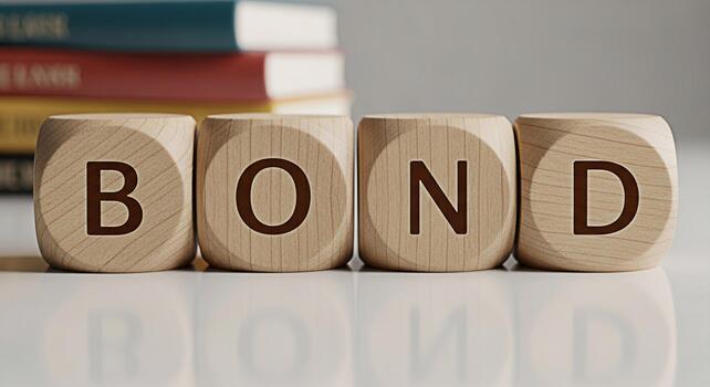 Wooden blocks spelling out BOND on a reflective surface in a bright studio setting representing financial security and investment opportunities for the future with books in the background photo