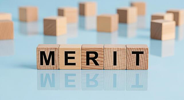 Wooden blocks spelling MERIT on a reflective blue surface representing achievement and success in a minimalist setting conveying a sense of accomplishment and recognition of value photo