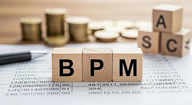 Wooden blocks spelling BPM and ASC on a financial document with coins and a pen representing business process management and assetbacked security in a financial setting conveying financial strategy photo