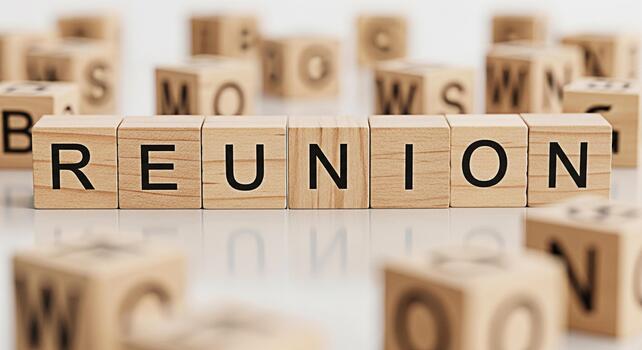 Wooden blocks spelling Reunion on a reflective surface surrounded by other lettered blocks symbolizing togetherness nostalgia and the joy of reconnecting with friends and family in a warm and inviting photo