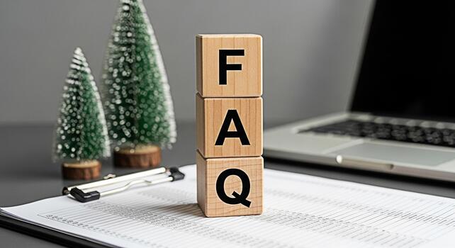 Wooden blocks spelling FAQ resting on a financial report with Christmas trees and a laptop in the background symbolizing holiday season business questions and support creating a festive yet profession photo