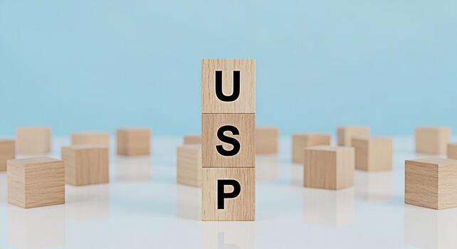 Wooden blocks displaying USP on a white surface against a light blue background representing Unique Selling Proposition and business strategy conveying a message of differentiation and competitive adv photo