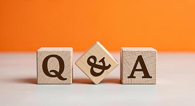 Wooden blocks displaying QA on a table against an orange backdrop symbolizing problemsolving and knowledge sharing in a bright and engaging setting perfect for educational and businessrelated content photo