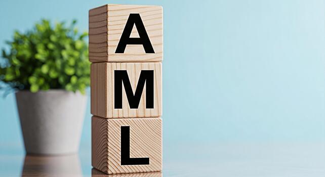 Wooden blocks displaying AML on a table in a bright studio representing AntiMoney Laundering compliance and financial regulation with a focus on preventing illicit financial flows and maintaining inte photo