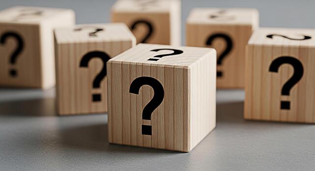 Wooden blocks displaying question marks on a gray surface representing uncertainty and the need for answers in business and personal life creating a mood of curiosity and problemsolving photo