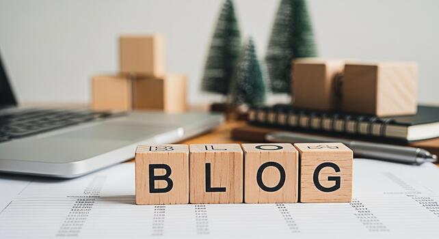 Wooden blocks spelling BLOG on a desk with a laptop and notebook symbolizing online content creation and digital marketing strategies for business success in a modern workspace photo