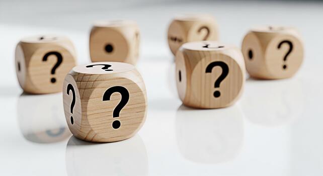 Wooden dice displaying question marks on a reflective white surface symbolizing uncertainty and the need for answers in a clean minimalist setting creating a sense of curiosity and problemsolving photo