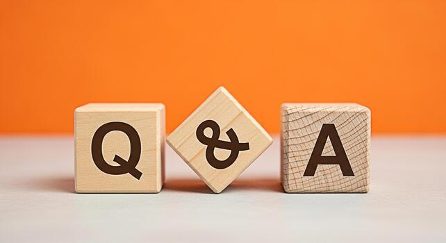 Wooden blocks displaying QA on a table against an orange backdrop representing questions and answers knowledge and problemsolving in a simple educational and informative manner photo