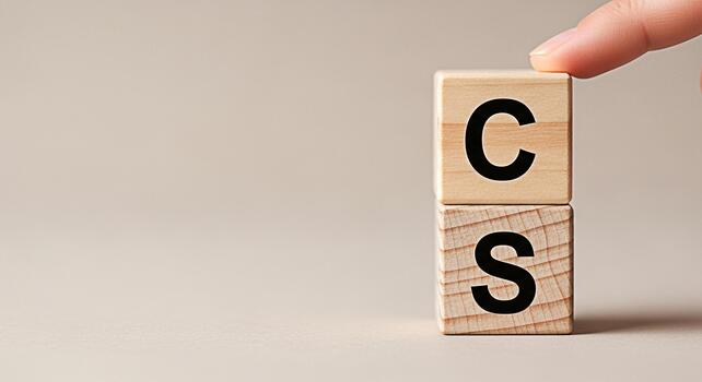 Finger adjusting wooden blocks with the letters CS on a neutral background representing customer satisfaction compliance standards or coding skills conveying a sense of precision and control photo