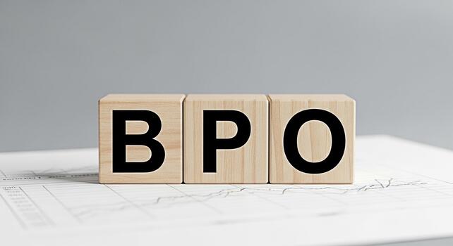 Wooden blocks displaying BPO on a financial report in a neutral setting symbolizing business process outsourcing and strategic decisionmaking for improved efficiency and cost reduction photo