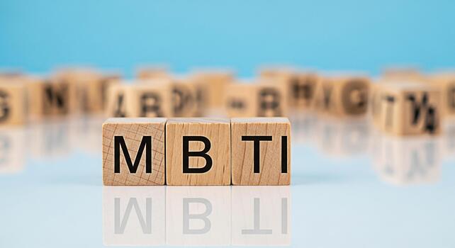 de madera bloques ortografía mbti en un reflexivo superficie en contra un azul antecedentes representando personalidad evaluación y psicológico tipos Fomentando conciencia de sí mismo y comprensión individual diferencia foto