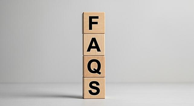 Wooden blocks displaying FAQs in a bright studio setting representing information accessibility and customer support symbolizing clarity and guidance for users seeking answers to common questions photo