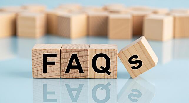 Wooden blocks spelling FAQs on a reflective blue surface representing frequently asked questions and information creating a clear and helpful atmosphere for customer support and online assistance photo