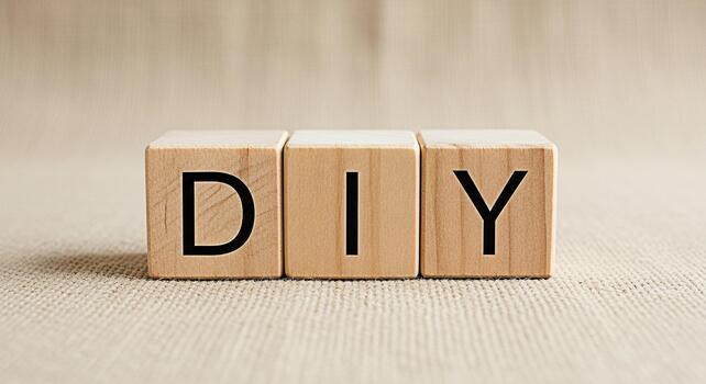Wooden blocks spelling DIY on a burlap surface representing creativity and crafting suggesting a doityourself project with a sense of accomplishment and handmade artistry in a neutral setting photo