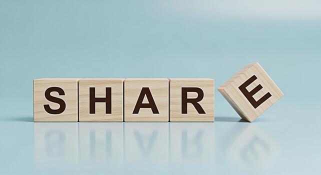 Wooden blocks spelling SHARE on a light blue surface emphasizing the concept of sharing and collaboration in a clean minimalist setting promoting a sense of community and information exchange photo