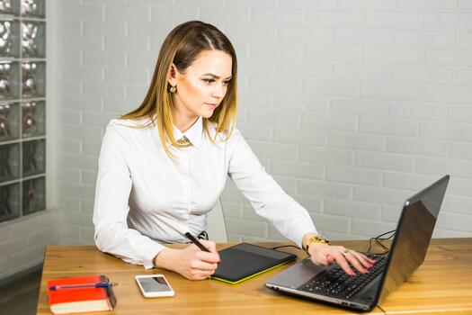female designer using graphics tablet while working with computer photo
