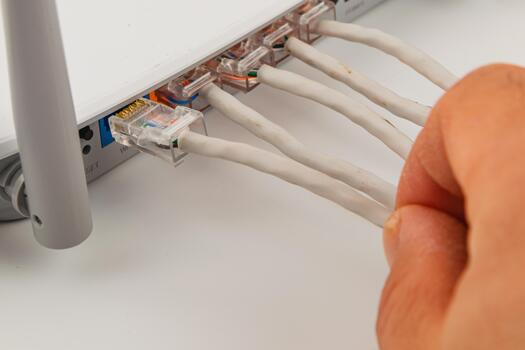 Connecting network cables to a router at home for internet access photo